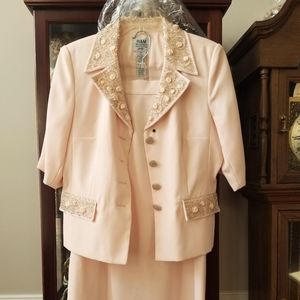 2 piece jacket and Long Skirt, light peachy pink in color. There are 3 spots